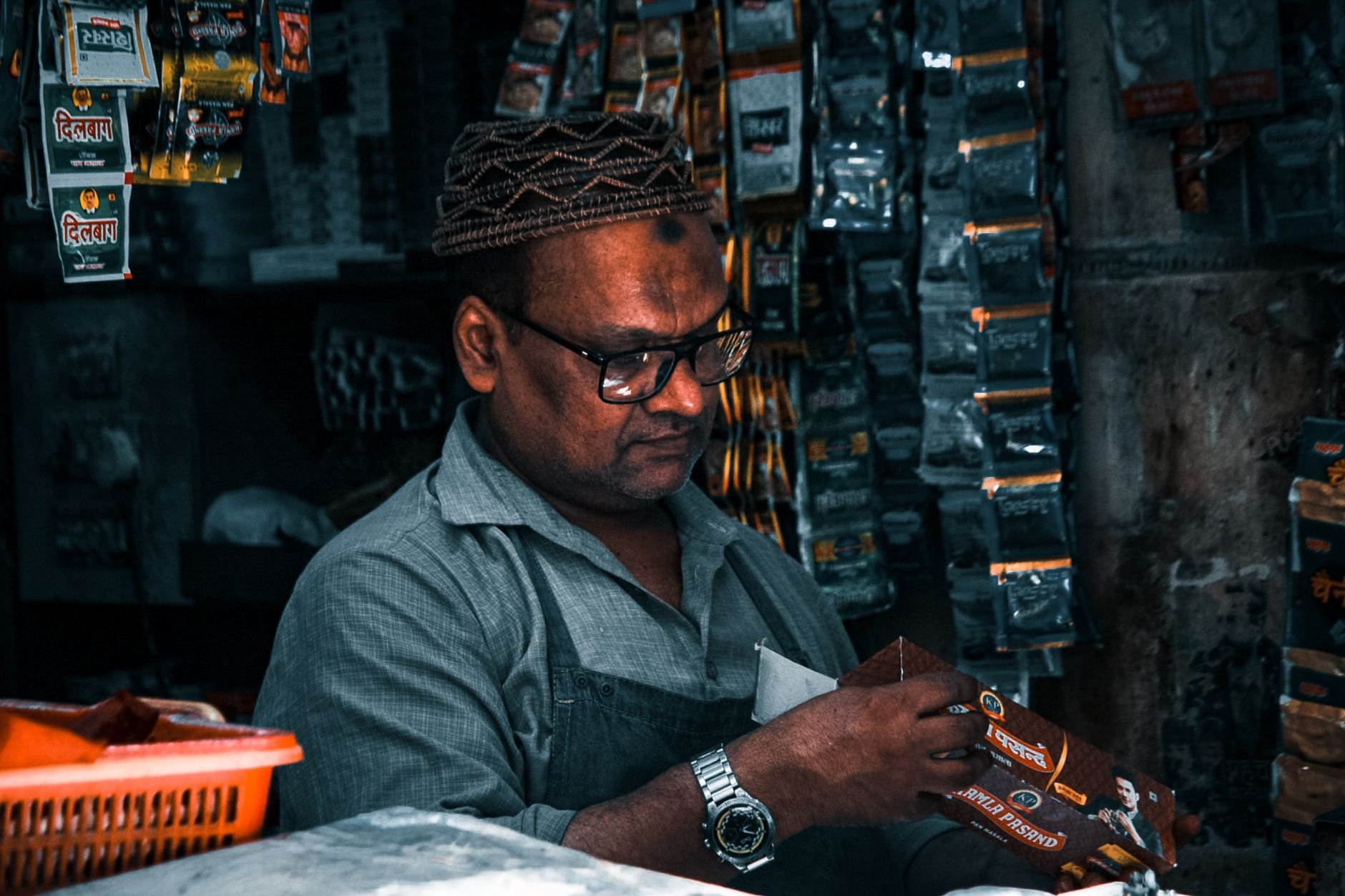 Smoke shop owner organizing product shelves in his store